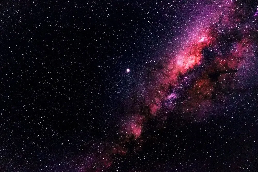 A purple night sky full of stars, the water sign Scorpio at its darkest hour