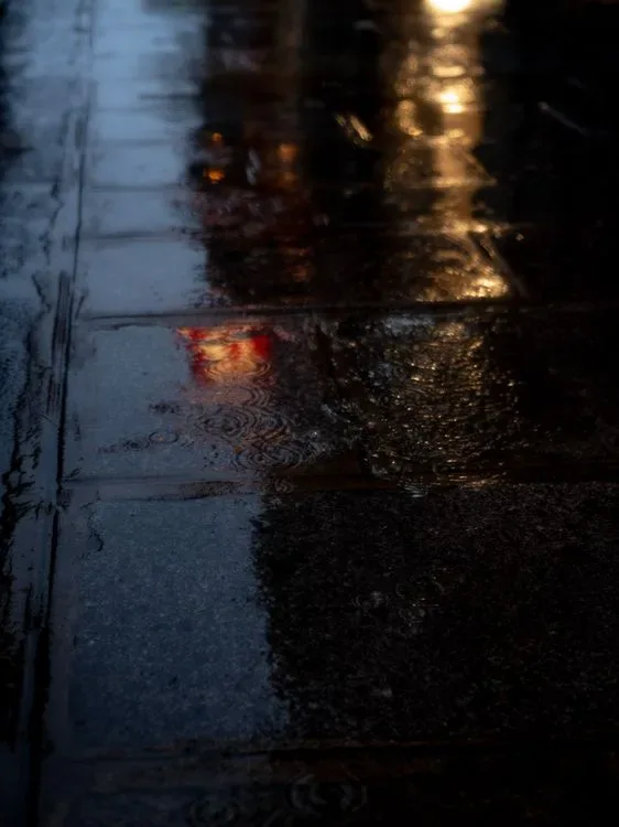 An empty road stretching into the dark at night