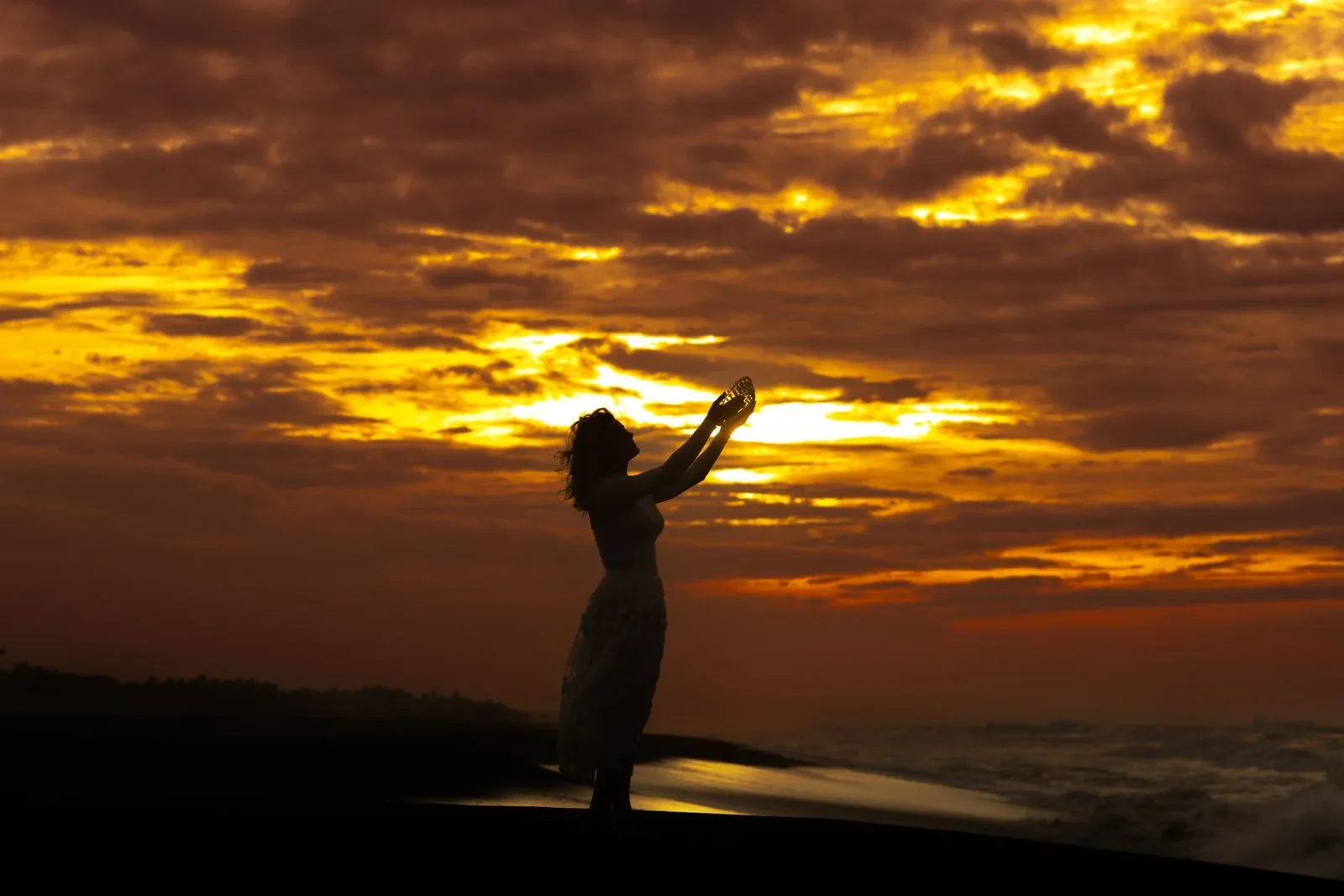 A person surrounded by golden sunset light, not a photographed aura