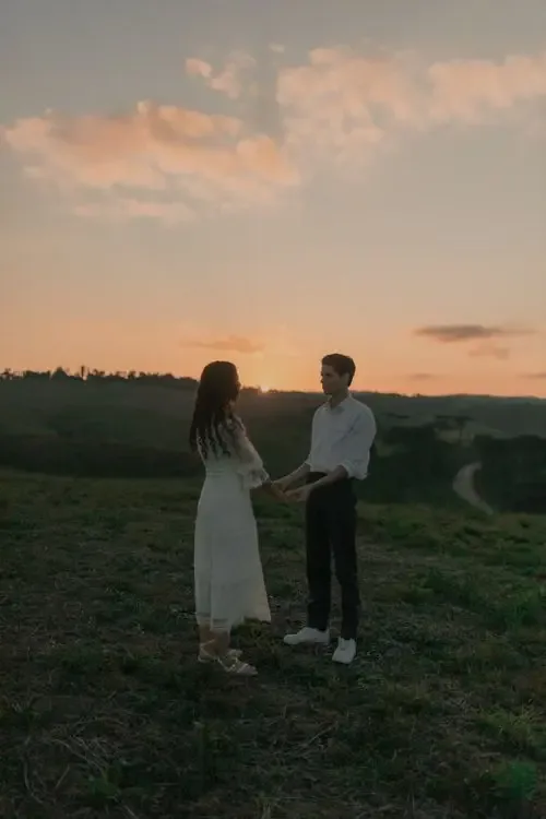A couple holding hands at sunset