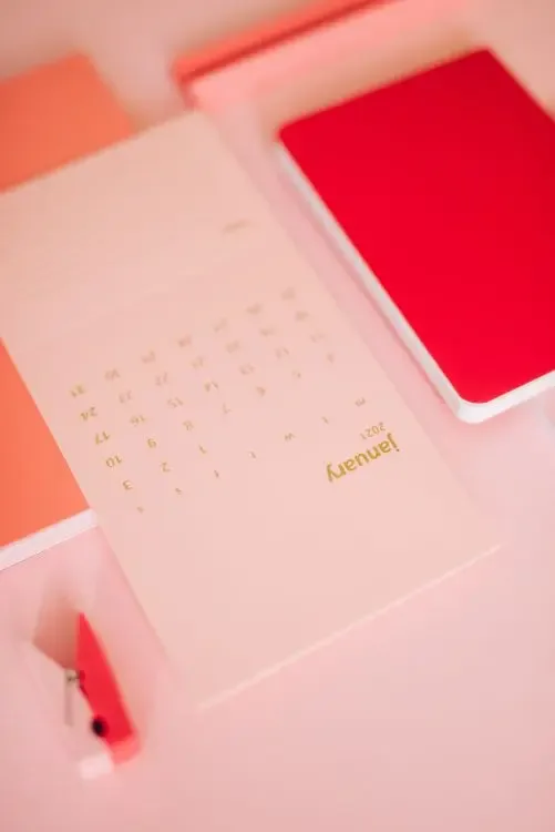 Open notebook and calendar on a desk, the Virgo habit of planning ahead