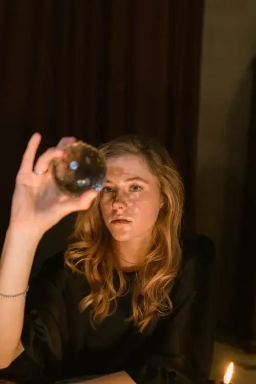 A woman holding a crystal ball, a common image of psychic ability