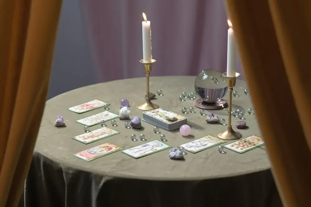 Tarot cards and a crystal ball on a table, the tools of a love reading