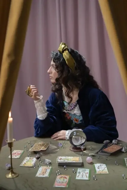 Woman sitting at the table with tarot cards