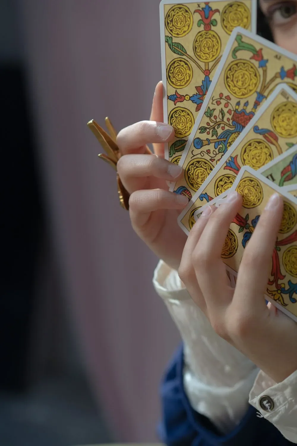A hand fanning out tarot cards, a reading in progress