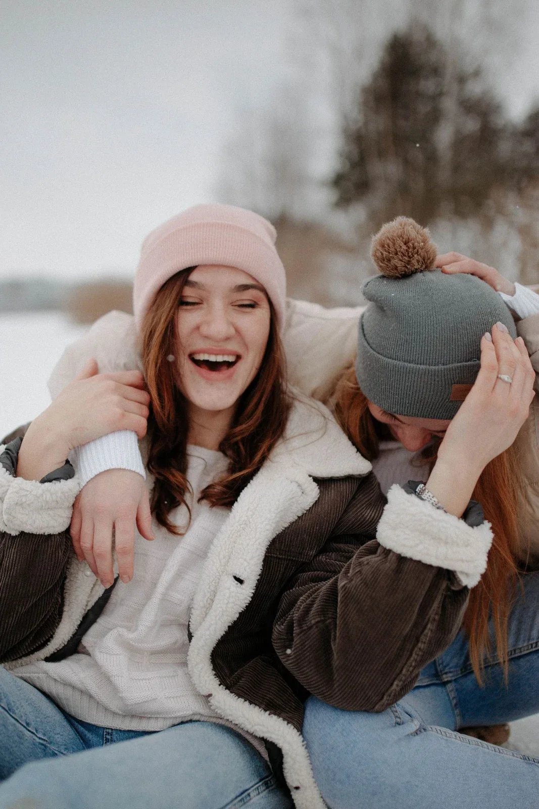 Two friends laughing together outdoors
