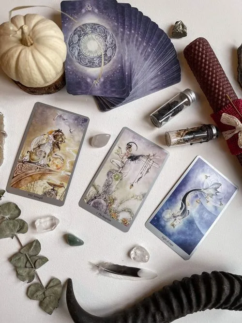 A close arrangement of tarot cards on a reading table