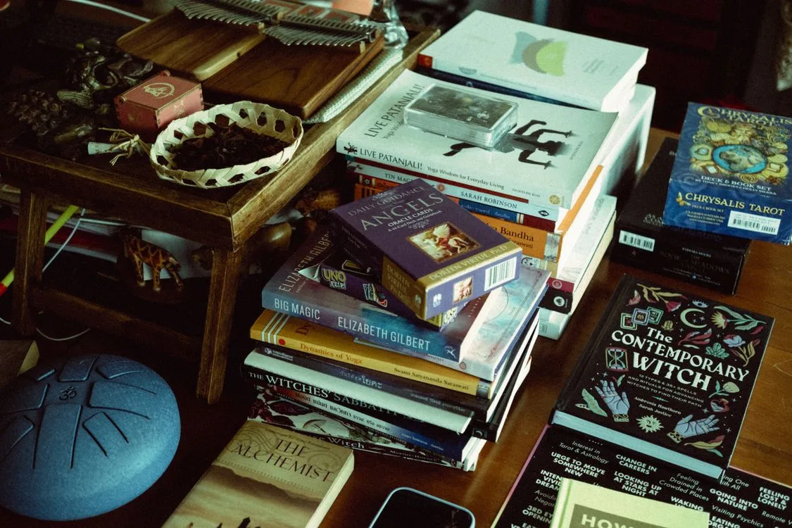 A tarot deck resting on a stack of books