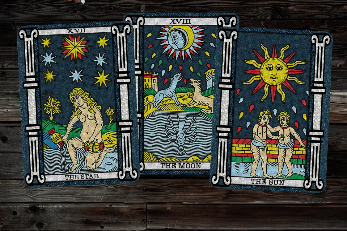 Tarot cards spread across a wooden reading surface